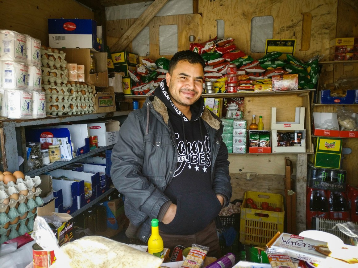 Sammy Hambod presiding over his grocery store in the Skaramagas camp outside Athens.