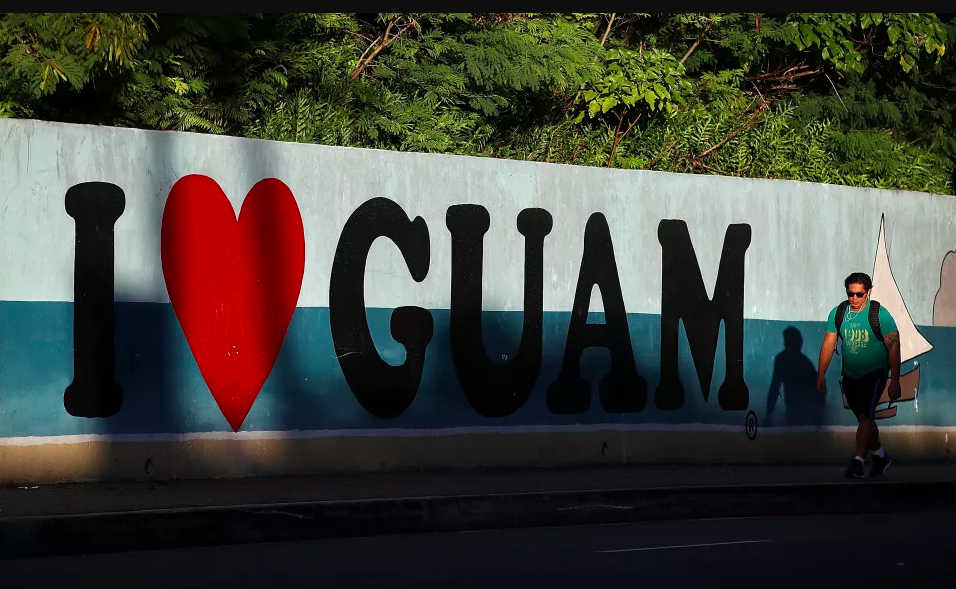 A pedestrian walks by a mural on August 14th, 2017, in Tamuning, Guam.