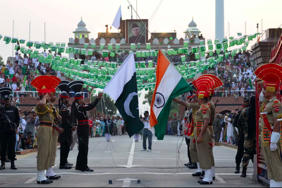 Pakistani Rangers (black) and Indian Border Security Force personnel (brown) perform during the daily beating of the retreat ceremony at the India-Pakistan Wagah Border Post, some 35kms west of Amritsar on August 14th, 2017. Pakistan celebrates its independence on August 14th, one day before India's independence day on August 15th.