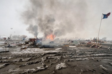 Activists departing the Dakota Access Pipeline protests burn their tents. Next month, we return to Standing Rock one year after the demonstrations.