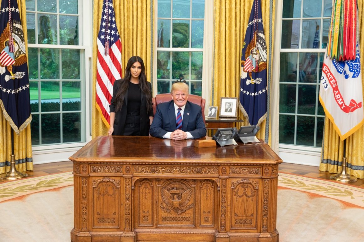 Kim Kardashian poses with President Donald Trump at the White House.