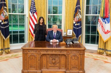 Kim Kardashian poses with President Donald Trump at the White House.