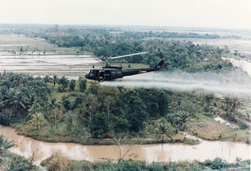 A U.S. Huey helicopter sprays Agent Orange over Vietnam.