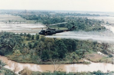 A U.S. Huey helicopter sprays Agent Orange over Vietnam.