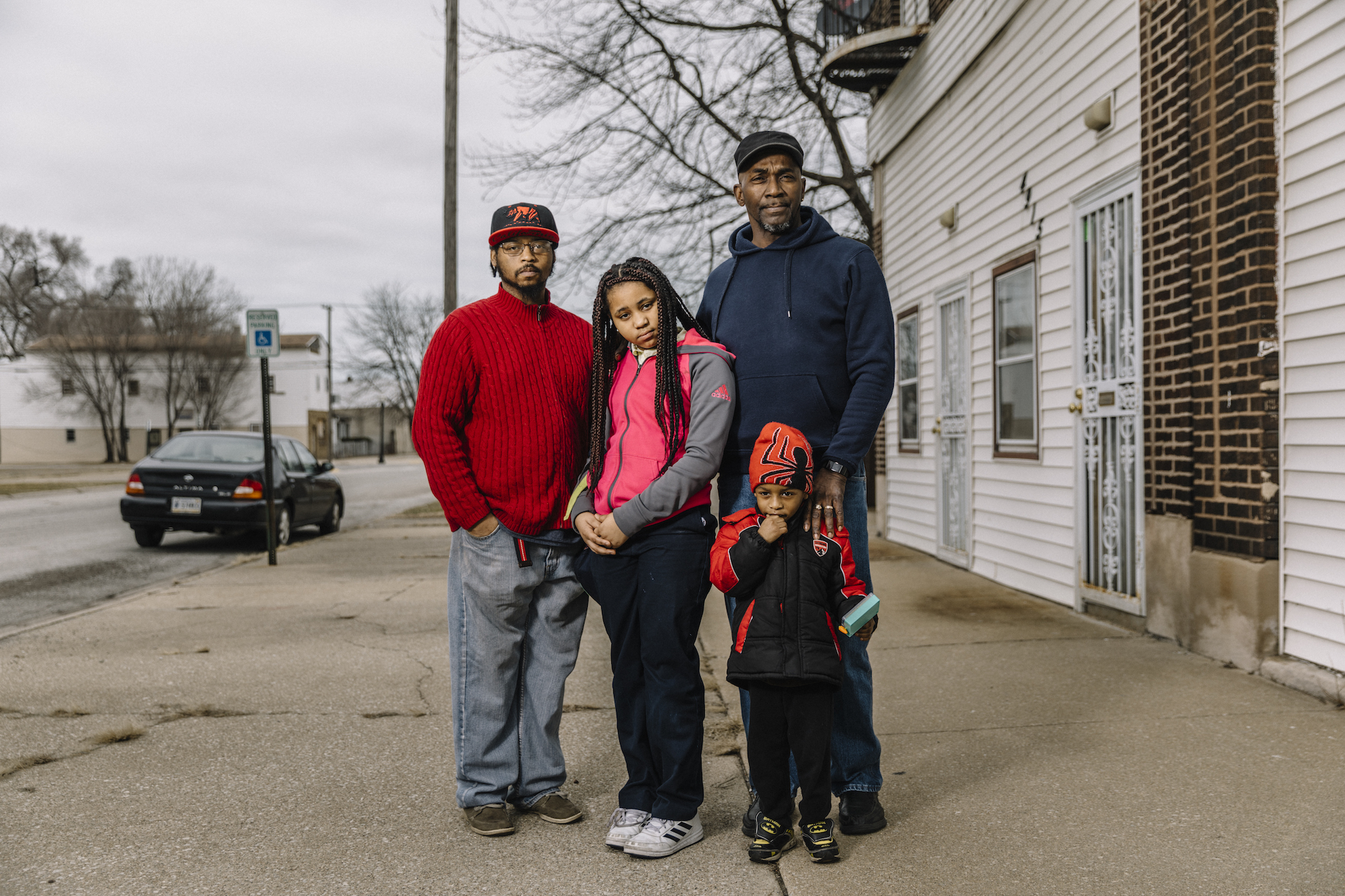 Devin Crymes (61) stands with his son James Boyd (36) and grandchildren Jania Boyd (10) and James Lee Boyd (four) in front of his house on Alexander Avenue, located in Zone 2 of the U.S.S. Lead Superfund site in East Chicago.