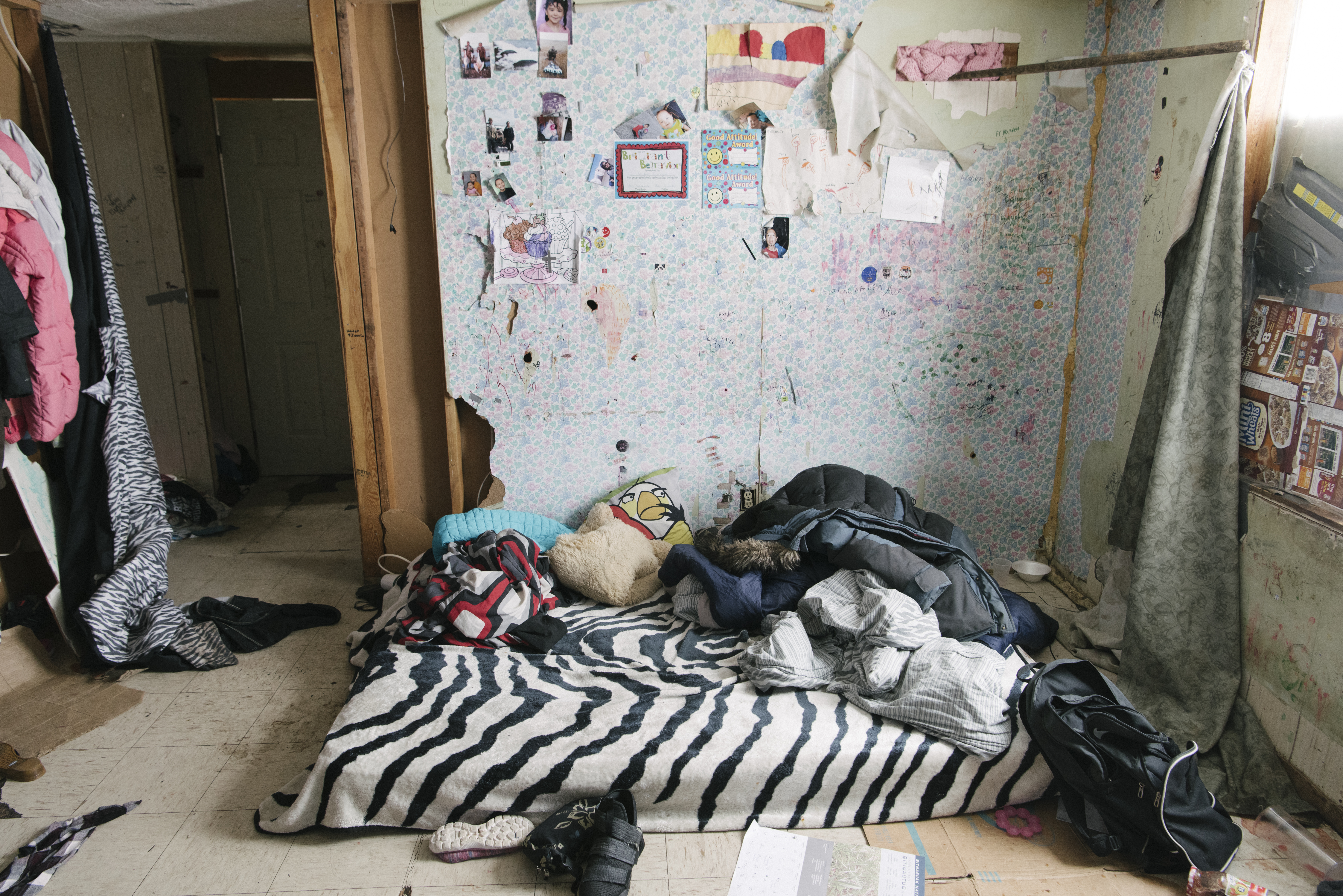 A single mattress covers the floor of a three-person household. Mattresses and furniture in general are scarce on Saint Lawrence Island, and nearly all structures appear to consist solely of exterior shells built by the U.S. government decades ago.